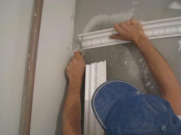 The ceiling skirting is glued before the wallpaper, as it is not known how the wall cloth behaves under the influence of adhesives and the weight of fillets
