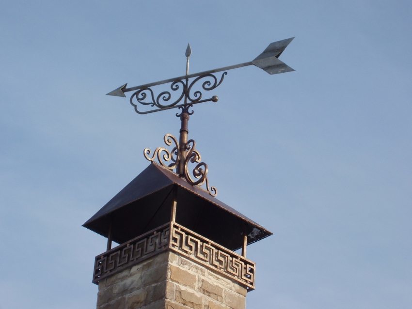 Forged visor on the chimney gives an aesthetic appearance of the exterior of the tube