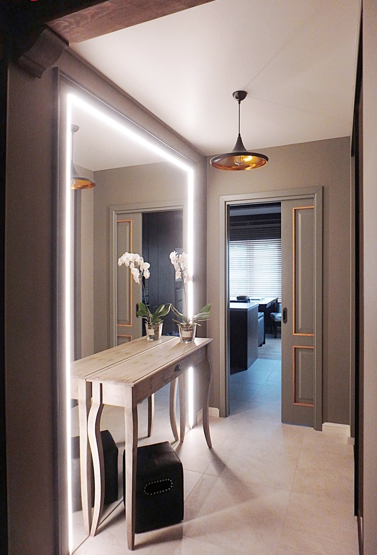 Stunning backlit mirror in the interior of the hallway