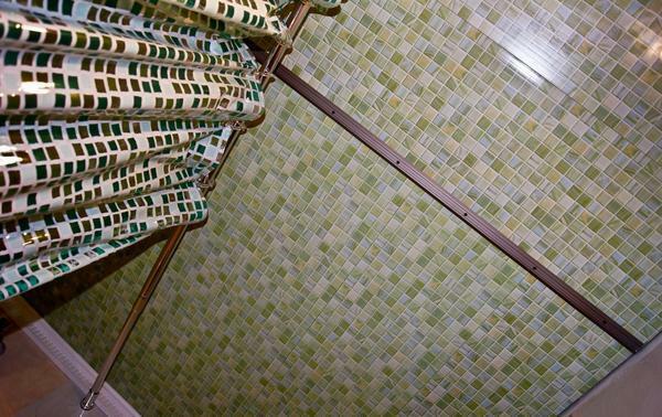 The ceiling in the bathroom is decorated with mosaic tiles, which have high performance characteristics