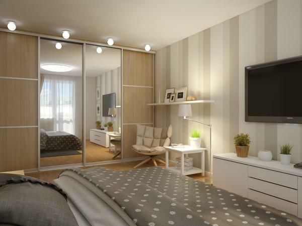 In the bedroom of rectangular shape, it is best to install a built-in wardrobe with mirrors