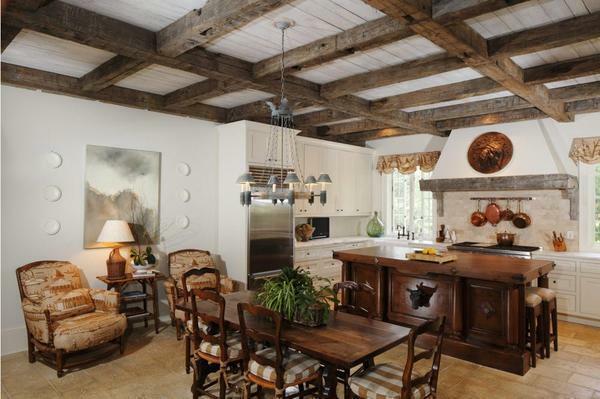 Ceilings with decorative beams decorate the interior of the room, made in a rustic style