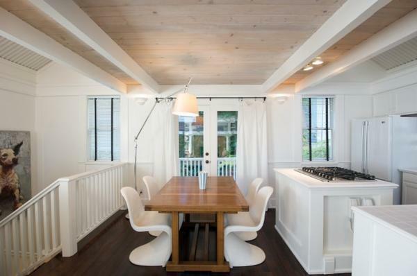 Decorative beams on the ceiling painted in the color of the interior will help create a cozy atmosphere in the room