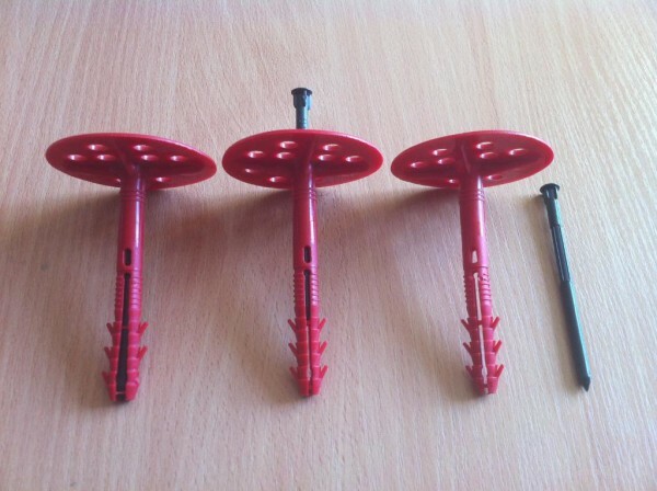 Plastic dowels with large washers for fastening insulation.