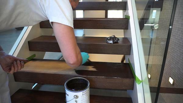 The last stage of the construction of a wooden staircase is painting or varnishing