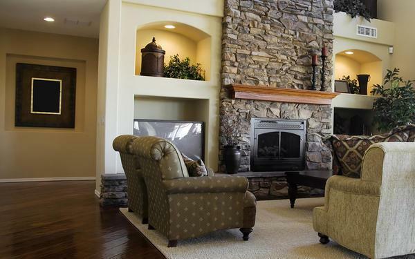 Especially elegant looks fireplace in the classic living room, surrounded by natural stone