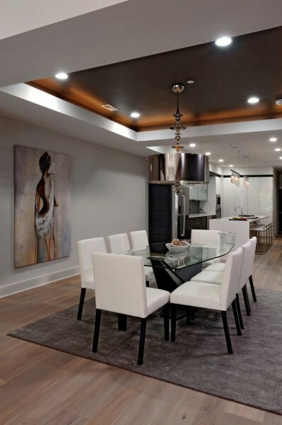 Spotlights on a tension ceiling can be installed at the same time with a chandelier