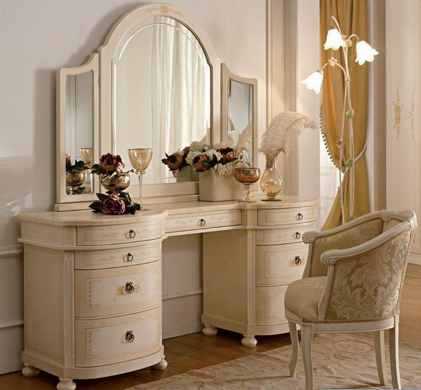 For a dressing table made in classical style, a wooden chair with soft upholstery is a good choice. If the table is made in high-tech style, then it is better to choose a pouf