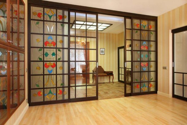 Sliding transparent interior partition with stained-glass windows