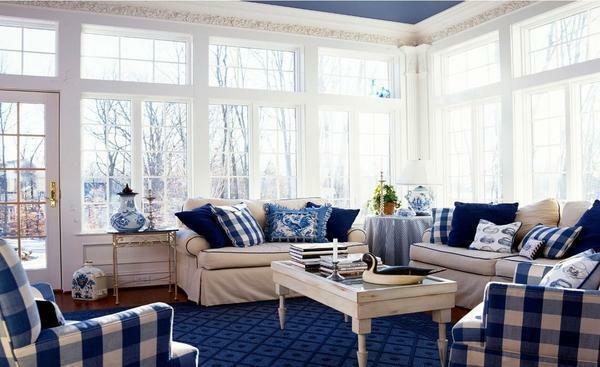 Hall in white and blue: interior of the living room in brown tones, dark color of decoration, photo and wall decoration