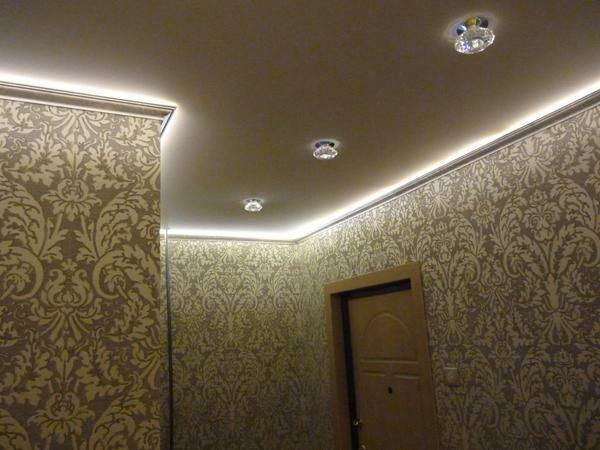 Often, the lighting of the stretched ceiling is carried out with the help of LED strips