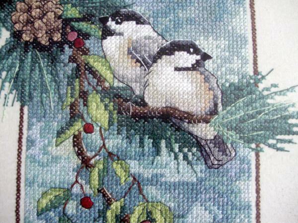 Embroidering with a cross of bullfinches will give your picture a new color and elegance
