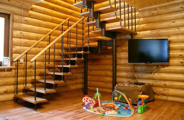 Metal staircase in a wooden house is a guarantee of construction reliability
