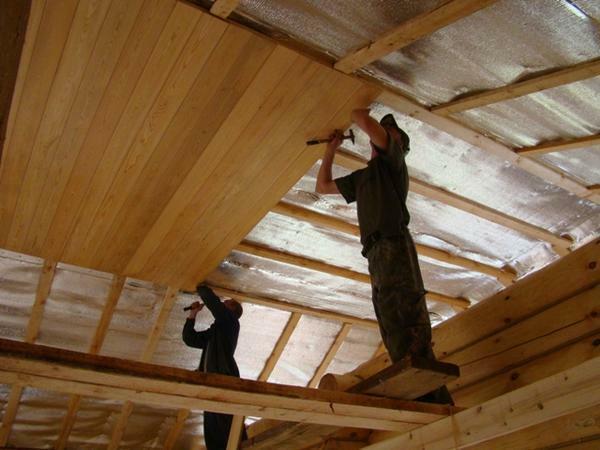 For a ceiling in a wooden house, you can apply almost any type of decoration
