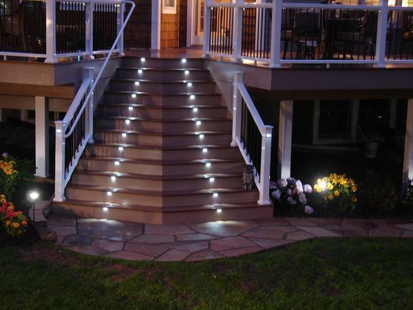 An excellent solution is to illuminate the staircase in the street with spotlights that are mounted on a stage