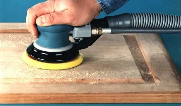 Grinding the cabinet door with a grinder