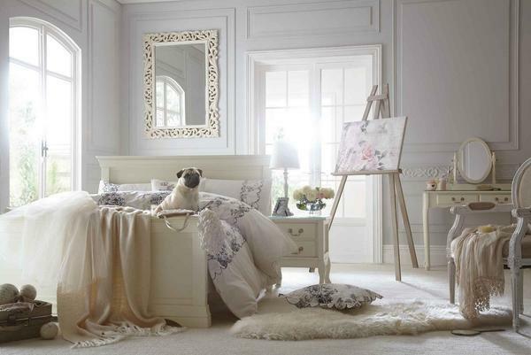 In the bedroom in the style of the shebbie-chic, a tall wooden bed painted in white