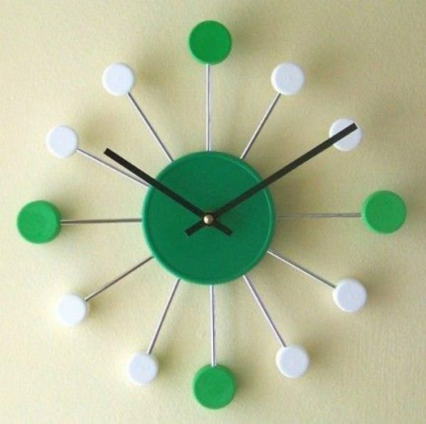Homemade original watch from the lids of plastic containers can be beneficial to stand out against the background of a furniture factory interior