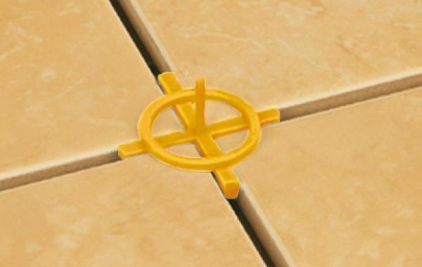Crosses for tile joints with jumpers fix and control the height of the laid covering