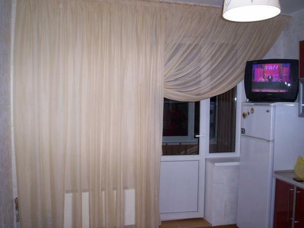 If the kitchen with balcony is small, then it can be visually expanded by hanging light curtains