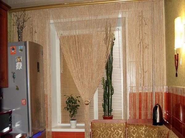 Thread curtains of gold color perfectly fit in the kitchen interior, made in a classic style