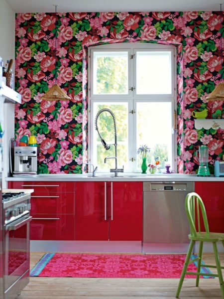 A riot of colors on the walls blends well with bright cabinet door.