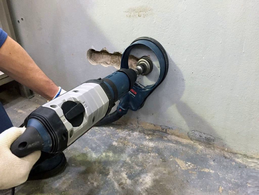Special tools and nozzles are used to drill holes in concrete walls.