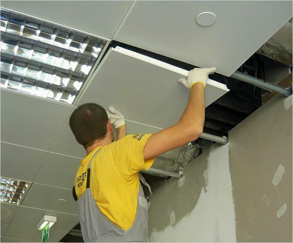 Completing the installation of a false ceiling, the installation of blind plates in the cells of the metal frame