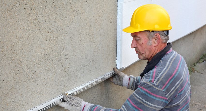 Polystyrene insulation of walls outside their own hands, video