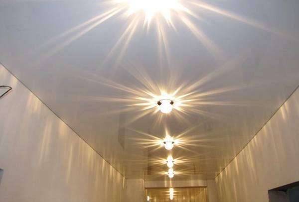 Monter vakre hvite spotlights i taket, kan du oppnå en fantastisk form for multippel refleksjon av lys på den blanke overflaten på nettet