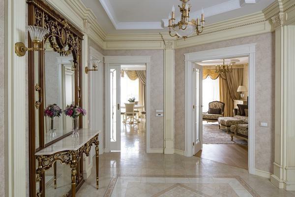In the hallway, made in the classical style, perfectly fit the mirror with a volumetric frame of gold or brown