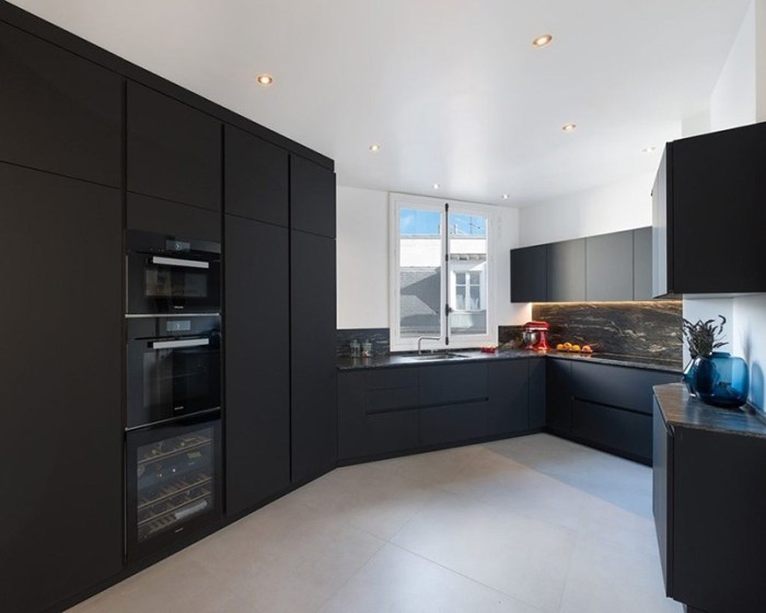 Black furniture against white walls, ceiling and floor