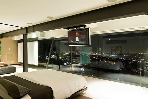 Mounting the TV to the concrete ceiling is not only a reliable, but also an original solution for your room