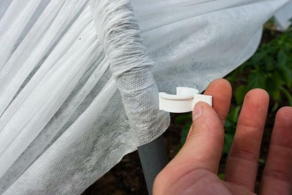 The greenhouse includes convenient clips for fastening the covering material