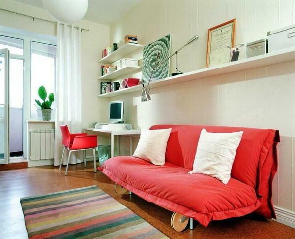 Add bright colors to the guest room with a stylish red sofa