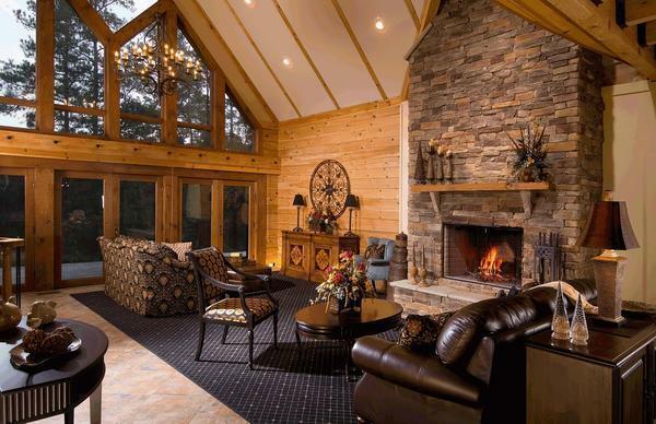 The fireplace, surrounded by natural stone, is perfect for a country-style living room
