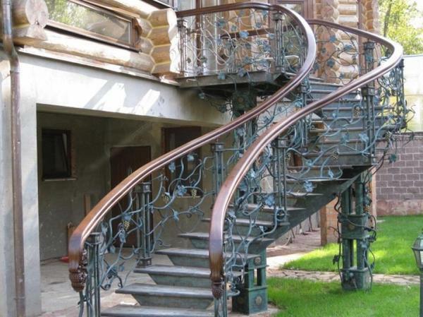 A metal staircase with forged rails will look beautiful and elegant in the country house