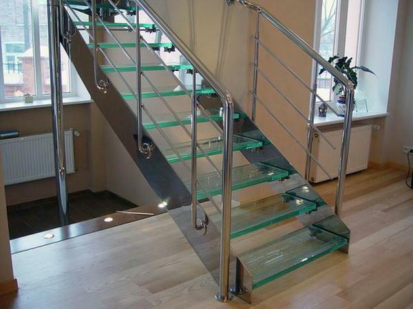 Gražus laiptai pagaminti iš stiklo ir metalo gerai dera interjere su dideliais langais